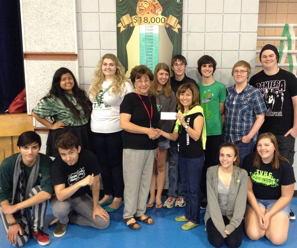 The Rincon Rotary Club of Tucson gives Tanque Verde High School a grant to assist them in their purchase of new theatre curtains.